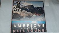 Front cover of the Neil Young LP titled 'American Stars 'n Bars' showing mountain landscape and artist photo.