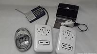 Photo showing all items including the portable radio, Jabra speaker, two PRIME chargers, car charger, and Energizer battery charger.