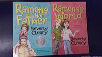 Photo showing two Ramona series children's books by Beverly Cleary: 'Ramona and Her Father' and 'Ramona's World'. Covers are colorful with illustrated characters.