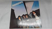 Front cover of Ramones Leave Home LP album featuring band photo and logo with blue background.