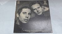 Front cover of Simon & Garfunkel Bookends vinyl LP showing black and white photo of the musical duo, with some wear and tear.