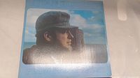 Front cover of Stan Rogers LP album From Fresh Water showing profile of Stan Rogers with fisherman's hat and wood post against cloudy sky.