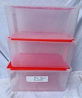 Three translucent GSC plastic storage containers stacked, each with a red flip top lid. Label on the front container indicates "Food - Plastic Containers".
