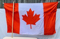 Photo showing the full Canadian flag with a measuring stick beside it indicating approximate height of 36 inches.
