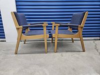 Pair of lounge chairs facing each other, side profile view