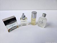 Four vintage Calvin Klein men's cologne bottles arranged side by side on a white background.