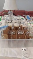 Plastic crate containing all 13 Baccarat stemware pieces arranged upright in cardboard inserts