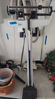 Full view of the vintage mechanical stand-on weight scale with sliding balance beam and platform base.