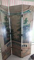 Full view of the three-panel room divider showing balcony scene with columns, floral vines and garden greenery.