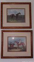 Two framed equestrian prints with wood-textured frames and beige mats, hung vertically on a white wall.