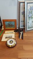 Overall lot displayed showing framed horse-themed and floral art pieces, two black wooden stands, and Fischer barometer with brass trim