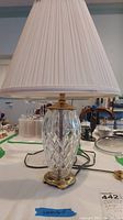 Full view of the Waterford crystal lamp with pleated fabric shade showing base and shade.