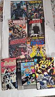 Photo showing 10 assorted Marvel comics including Black Panther, Daredevil, Thor, Punisher, and Spider-Man