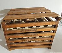 Side view of the wooden egg crate with Twin Brook Farms stamped on it.
