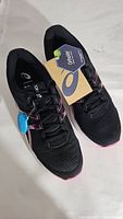 Top view of black ASICS Gel Contend sneakers with tags attached, showing size and brand information.