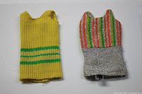 Front view of the two mini dresses; yellow knit with green stripes on left, silver glittery with vertical stripes on right