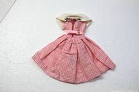 Pink gingham full skirt Barbie dress laid flat showing front with cream cowel collar, pink belt, and full skirt.