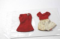 Two vintage doll dresses: red Barbie velvet mini dress with rhinestone pin and red velvet/white satin Skipper dress.
