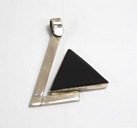 Front view of the triangular black onyx stone set in a sterling silver triangular frame pendant with bail.