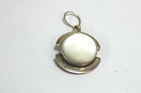 Front view of the round moonstone pendant set in sterling silver with a silver bail.