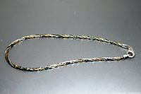 Image showing the twisted design of the sterling silver and gold tone bracelet with the clasp visible