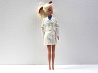 Full view of the 12-inch vintage Barbie doll standing upright, dressed in white uniform with name tag 'Barbie DDS' and a red ribbon in her blonde ponytail.