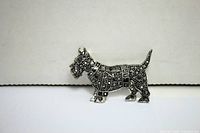 Silver-tone Terrier brooch with marcasite decoration, front view showing detailed marcasite pattern on the body and head.