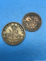 Front sides of the 1854 Large Penny and Half Penny tokens from the Bank of Upper Canada.