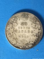 Reverse side of the 1919 Canadian 50 cent coin showing denomination, year, maple leaf wreath, and crown