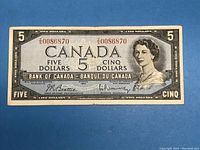 Front side of 1954 $5 Canadian banknote showing Queen Elizabeth II portrait and serial number 0086870
