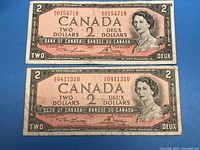 Front side of both 1954 Canadian $2 banknotes side by side showing portraits and serial numbers