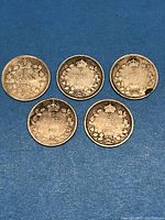 Five Canadian silver five-cent coins from early 1900s showing dates 1903, 1906, 1910, 1912, and 1916 with visible circulation wear.