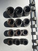 Top-down view of all 12 sockets arranged on the holder showing socket sizes and wear.