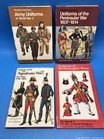 Four hardcover books on military uniforms from different historical periods, with illustrated covers depicting soldiers in uniform.