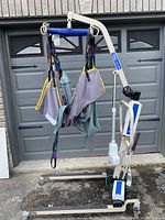 Invacare Reliant 450 patient lift assembled, front view showing frame, boom, legs and slings