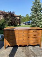 Photo showing front view of vintage Dixie Furniture long dresser outdoors.