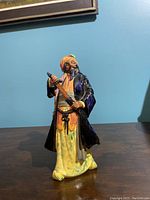 Front view of Blue Beard ceramic figurine showing detailed colors and sword.