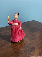 Side view of the Royal Doulton figurine showing a girl in a pink dress holding a mirror