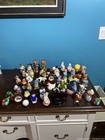 Full view of all salt and pepper shakers displayed on a dark wooden surface
