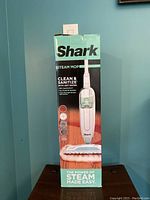 Photo of the original Shark Steam Mop box with product image and descriptions on packaging