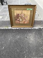 Full view of the vintage floral watercolour painting by Myrle Wilson in an ornate gold frame, placed outdoors on pavement showing condition and frame damage.
