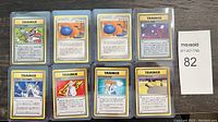 All eight Japanese Pokémon Trainer cards from 1996 displayed in protective sleeves.
