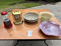 Entire lot overview showing all items on a wooden table outdoors.