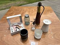 Photo showing the entire household items collection on a wooden table outdoors.