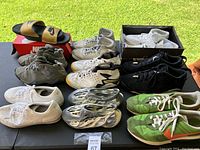 All shoes arranged showing variety including sneakers, slides, foam runners, different colors and brands.