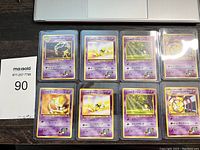 Top-down photo showing all 8 Japanese Pokémon cards in protective sleeves arranged in two rows of four. Cards show Psychic-type Pokémon with purple card backs and Japanese text.