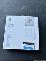 Front view of sealed Square Reader box showing product image and payment methods accepted (contactless, chip, magstripe).