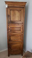 Front view showing four raised panel doors