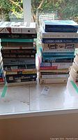 Photo of two stacks of books showing titles and authors