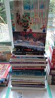 Stack of assorted books with visible titles about flowers and gardening.